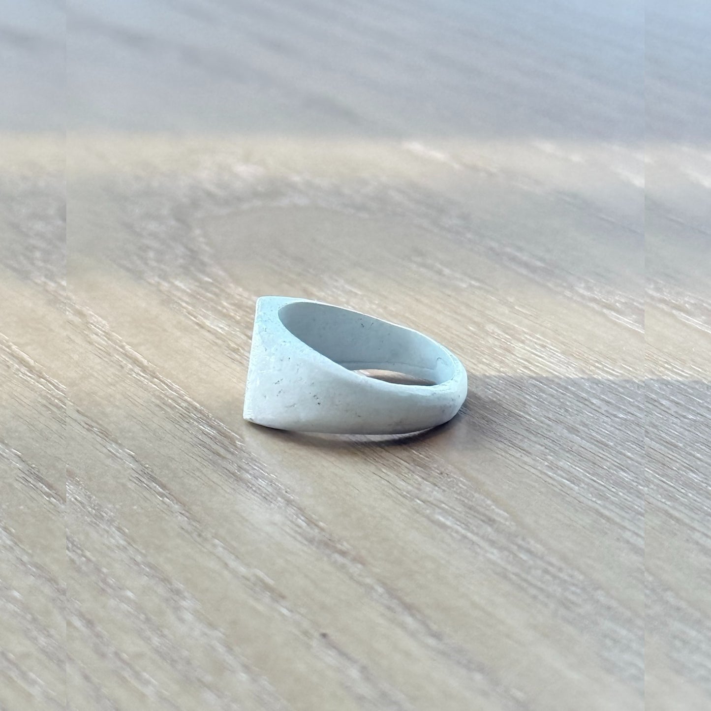 Detail of artisan silver ring’s burnt white finish and natural handcrafting marks on the 999 fine silver band, by Cici Dream
