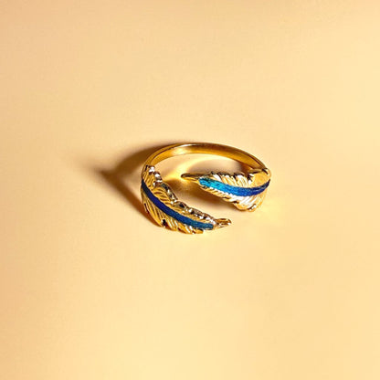 Echo Feather Open Spiral Ring by Cici Dream with iridescent colours shifting in light.