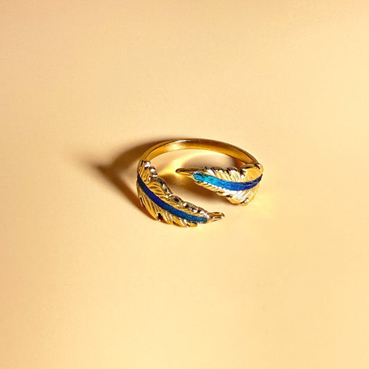 Echo Feather Open Spiral Ring by Cici Dream with iridescent colours shifting in light.